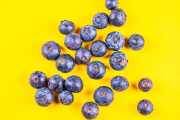 fresh blueberries on yellow  background