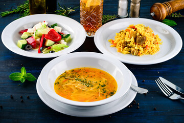 Top view of a three course set menu served on wooden table