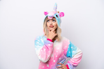Obraz na płótnie Canvas Young Russian woman with unicorn pajamas isolated on white background having doubts and with confuse face expression