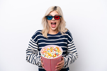 Young Russian woman isolated on white background with 3d glasses and holding a big bucket of popcorns