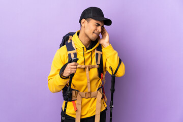 African American man with backpack and trekking poles over isolated background with headache