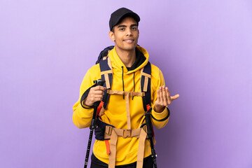 African American man with backpack and trekking poles over isolated background inviting to come with hand. Happy that you came