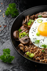 Bowl of Buckwheat with mushrooms, onion and egg. Healthy food