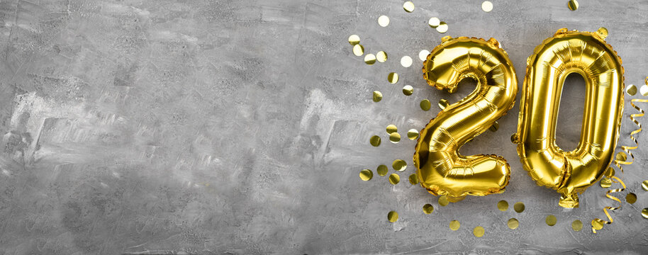 Yellow foil balloon number, number twenty on a concrete background. Birthday card with inscription 20. Anniversary concept. for anniversary, birthday, new year celebration. banner,