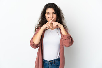 Teenager Russian girl isolated on white background showing a sign of silence gesture