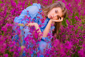 very beautiful girl with bright flowers on a flower field. Bright flower field with colored flowers