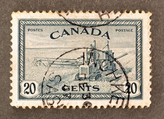 cancelled postage stamp printed by Canada, that shows Combine Harvesting, circa 1946.
