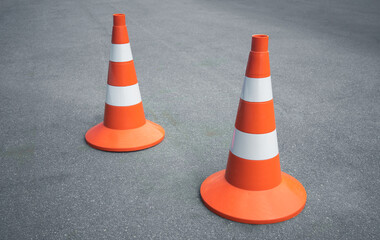 Orange construction cones on an asphalt road. Freeway construction. Passing the driver's license exam.