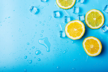juicy fresh lemon slices and ice cubes on a blue background. Top view, flat lay