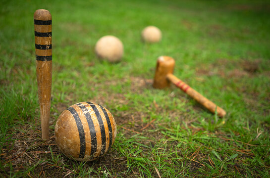 Wooden balls for playing croquet. Croquet balls on a field with green grass.
