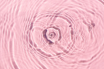 Fototapeta na wymiar Splashes on pink water under sunlight. Top view, flat lay