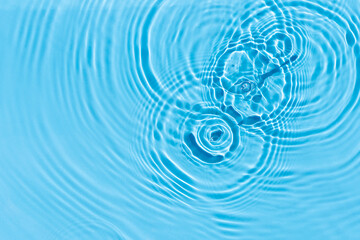 Drops and bulbs on blue water under sunlight. Top view, flat lay