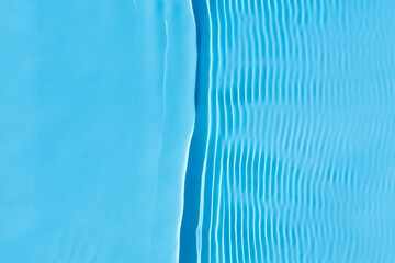 Water blue waves under the sun. Top view, flat lay