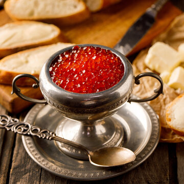 Red Caviar with bread and butter, with great background, glass, Jar, with glass of wine.