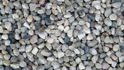 Background of large pile gray gravel stone pebbles, used in construction. Construction material concept. Selective focus. Top view. - 493775468