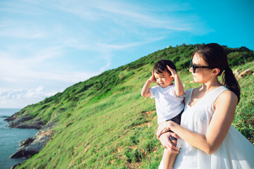 Mother with son traveling in Thailand active vacation mom and child hiking together on mountain...