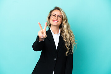 Brazilian business woman over isolated background smiling and showing victory sign
