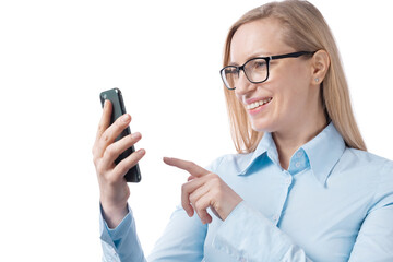 Business woman in eyeglasses and blue shirt using modern smartphone over white studio background. Successful mature blonde working on gadget indoors.