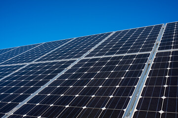 Solar panel of a solar park. Photovoltaic modules of a Solar energy power plant producing sustainable energy to prevent climate change.