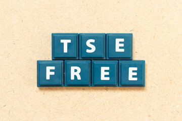 Tile alphabet letter in word TSE (Transmissible Spongiform Encephalopathy) free on wood background