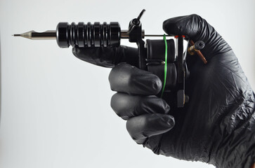 Grabbing Tattoo Machine On Isolated White Background 
