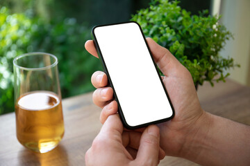 male hands holding phone with isolated screen in cafe