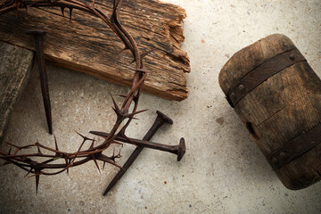 Crucifixion Of Jesus Christ. Cross With three Nails And Crown Of Thorns on ground