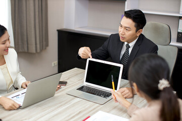 Collaborative process of professional businesspeople going over on new project together, using computer presentation and brainstorming ideas, coworker and working together at office meeting concept