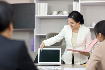 Collaborative process of professional businesspeople going over on new project together, using computer presentation and brainstorming ideas, coworker and working together at office meeting concept