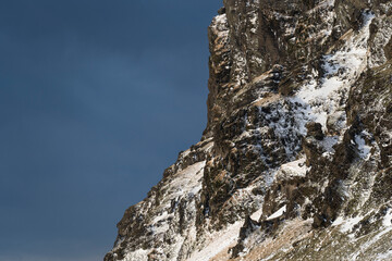 Snow covered mountain in iceland, and dark sky in the background