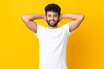 Fototapeta na wymiar Young Moroccan man isolated on yellow background laughing