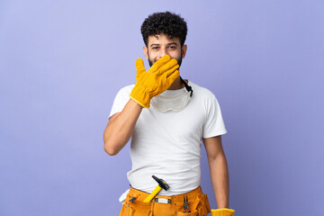 Young electrician Moroccan man isolated on purple background happy and smiling covering mouth with hand