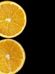 orange slices on the black background with copy space. 