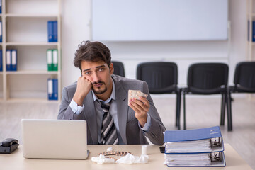 Young businessman employee suffering at workplace