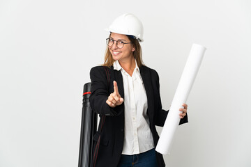 Middle age architect woman with helmet and holding blueprints over isolated background showing and lifting a finger