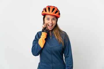 Middle age cyclist woman isolated on white background shouting with mouth wide open