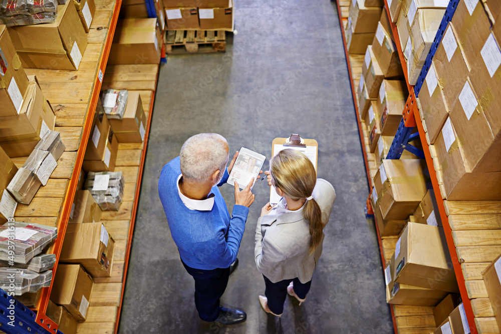Aufkleber we take the guesswork out of shipping. high angle shot of a two managers working on a digital tablet