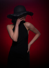 Mysterious girl is hiding her face with her hand