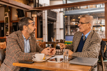 Having a serious conversation on their meeting in the cafe while drinking tea