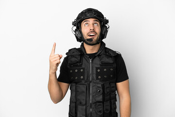 Young caucasian swat isolated on white background pointing up and surprised
