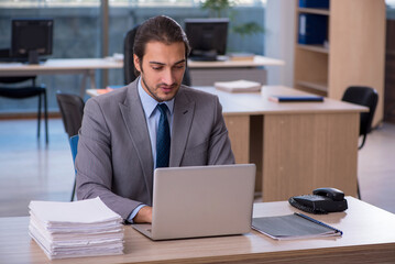 Young male employee working in the office