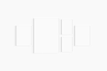 Gallery wall mockup. Set of 5 white frames. Gallery wall frame mockup. One 50x70 (5:7), two 30x40 (3:4), and two A4 (5:7) white frames.