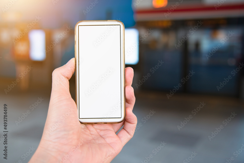 Poster Hand holding smart phone with blank screen for mockup while waiting for the bus
