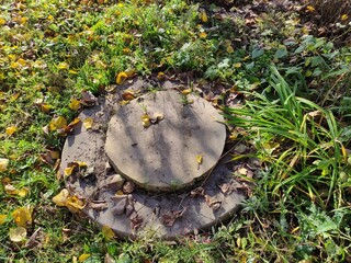 Septic tank hatch on the ground in the garden