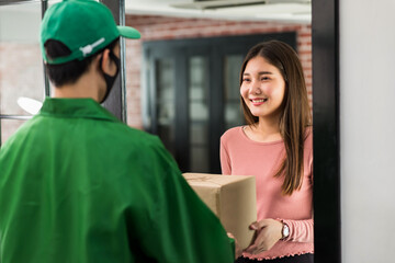 Asian woman receive delivery parcel from courier man in condo - obrazy, fototapety, plakaty