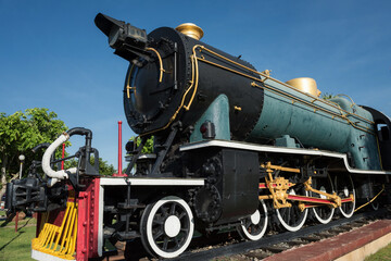 Antique steam locomotive train on rail in sunny day