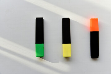 Fototapeta premium Colored markers on a white background in the light