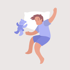 Little boy with toy sleeping sweetly in his bed on pillow. 