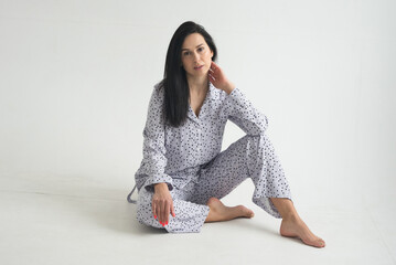beautiful brunette adult girl in femine pajamas sleep wear homewear on white background