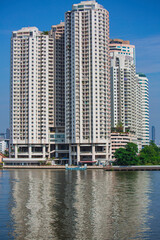 Fototapeta na wymiar Condo at afternoons front the river background blue sky